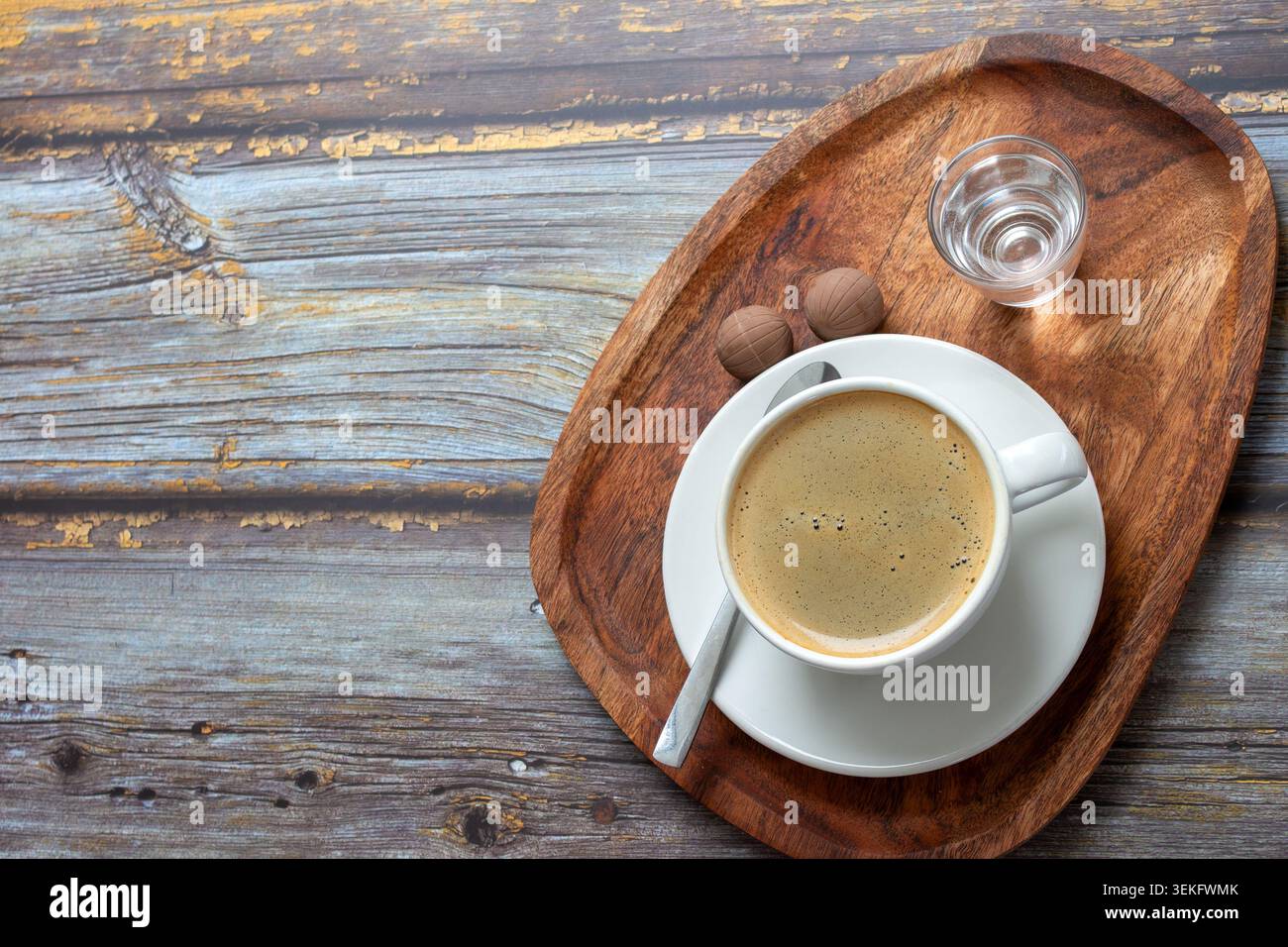 Warm coffee sits in a white cup Stock Photo