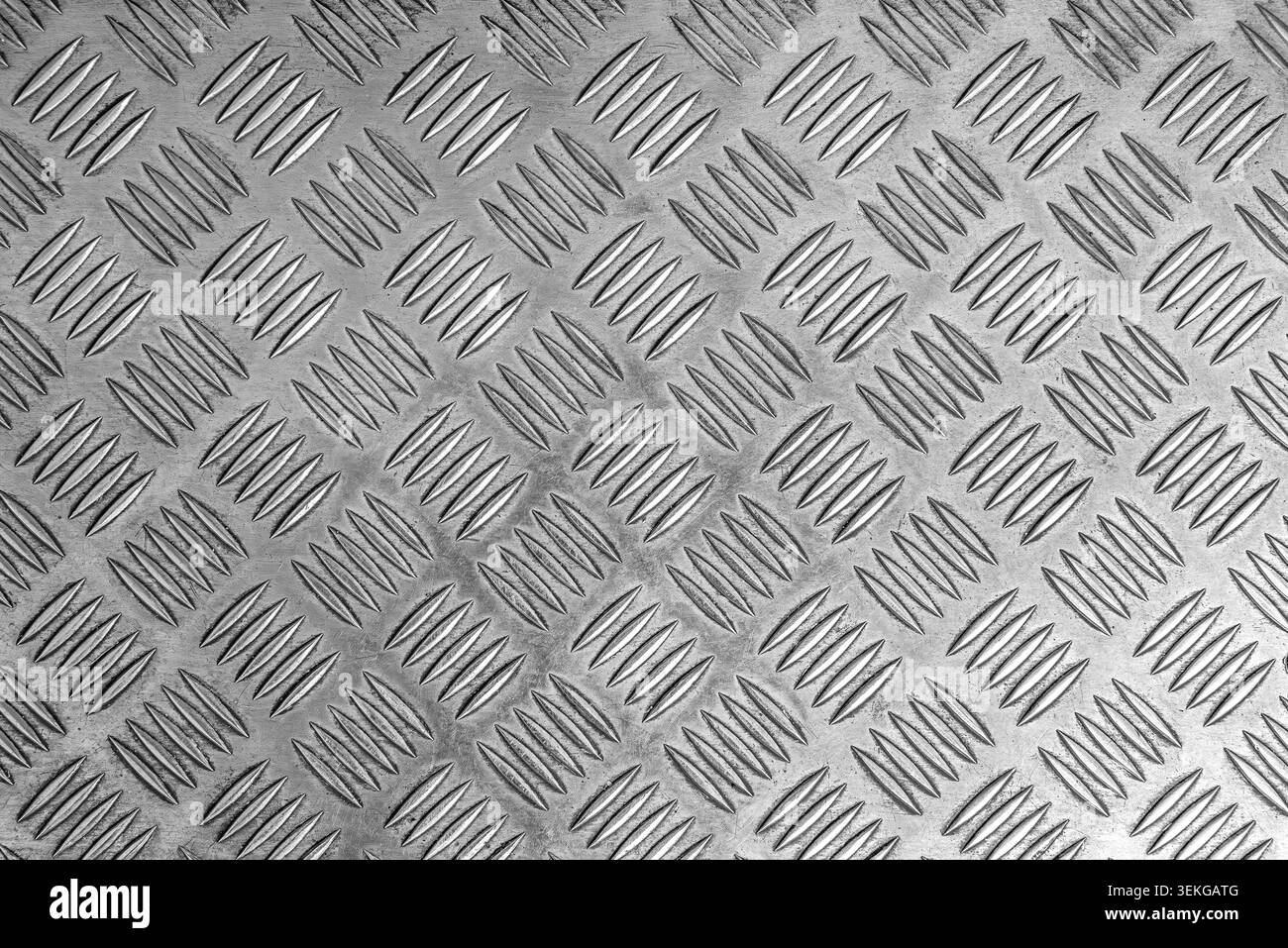 A silver metal diamond plate surface. Stock Photo