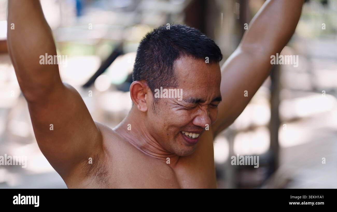 Man pushing limits during street workout, showing effort and determination Stock Photo