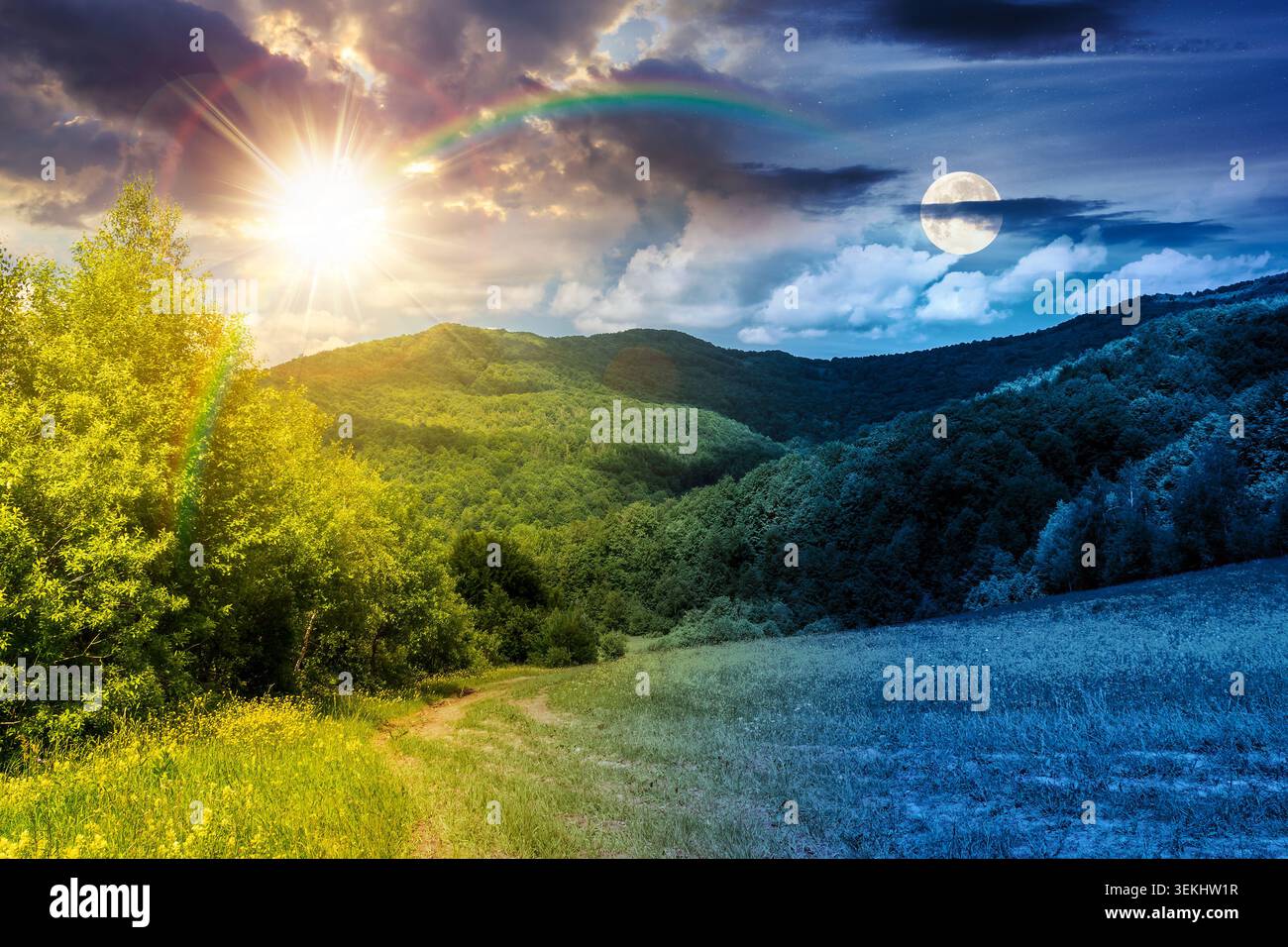 day meet night in beautiful countryside. epic view landscape in mountains on summer solstice. sun and moon in harmony over trail through the grassy fi Stock Photo
