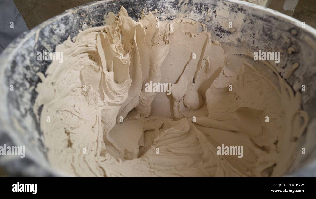 Mixed plaster paste in construction bucket closeup Stock Photo