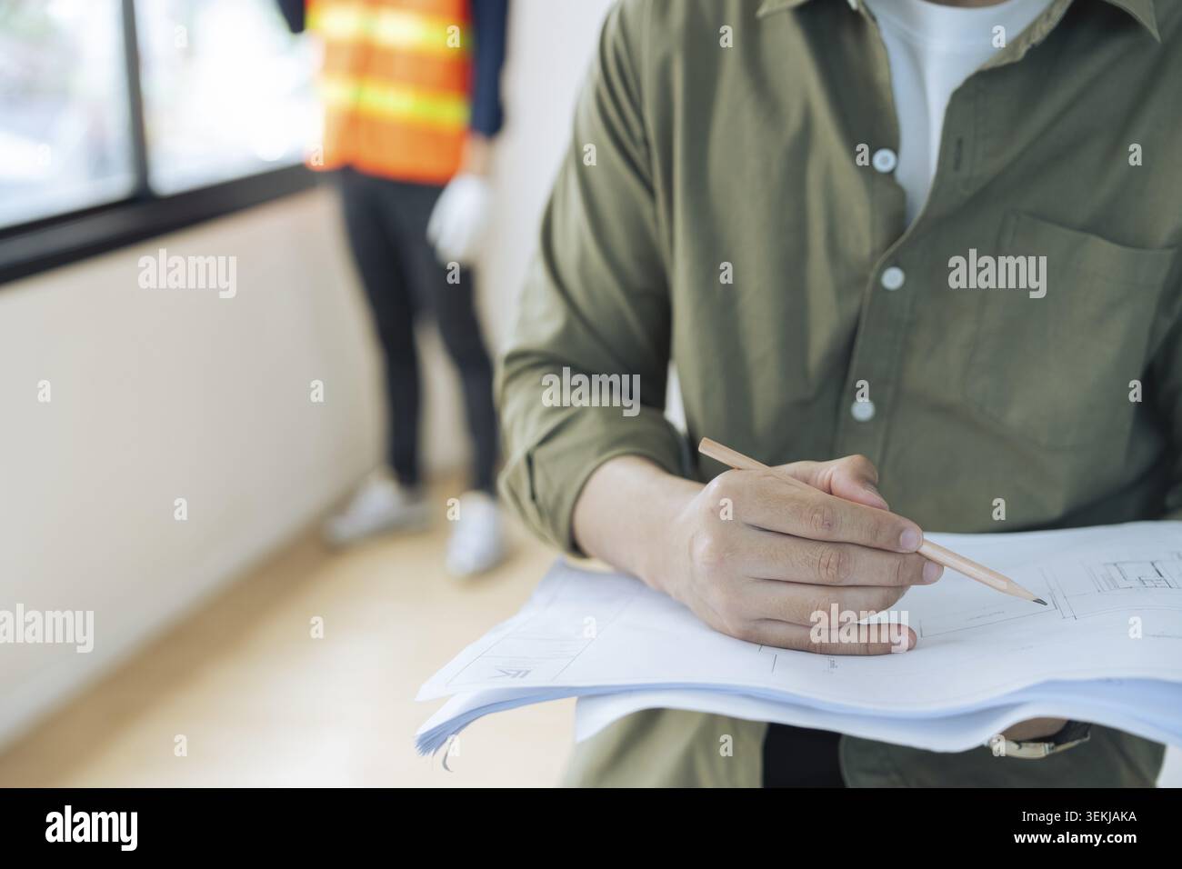 Construction engineer with architect team working check building construction progress at construction site Stock Photo