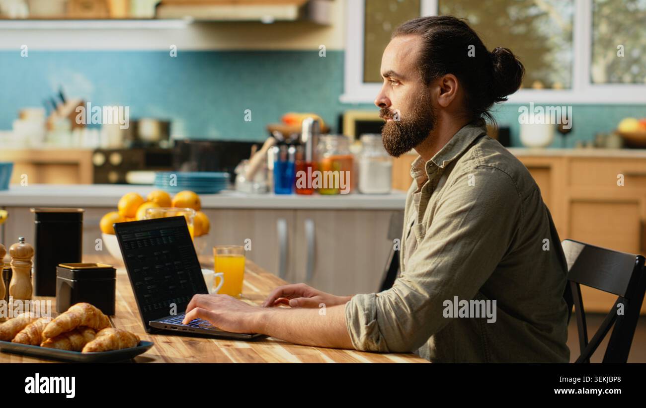 Man focused on programming and software development tasks. Laptop screen displays code, scripts and binary data, illustrating system maintenance and remote work in a high-tech occupation. Stock Photo