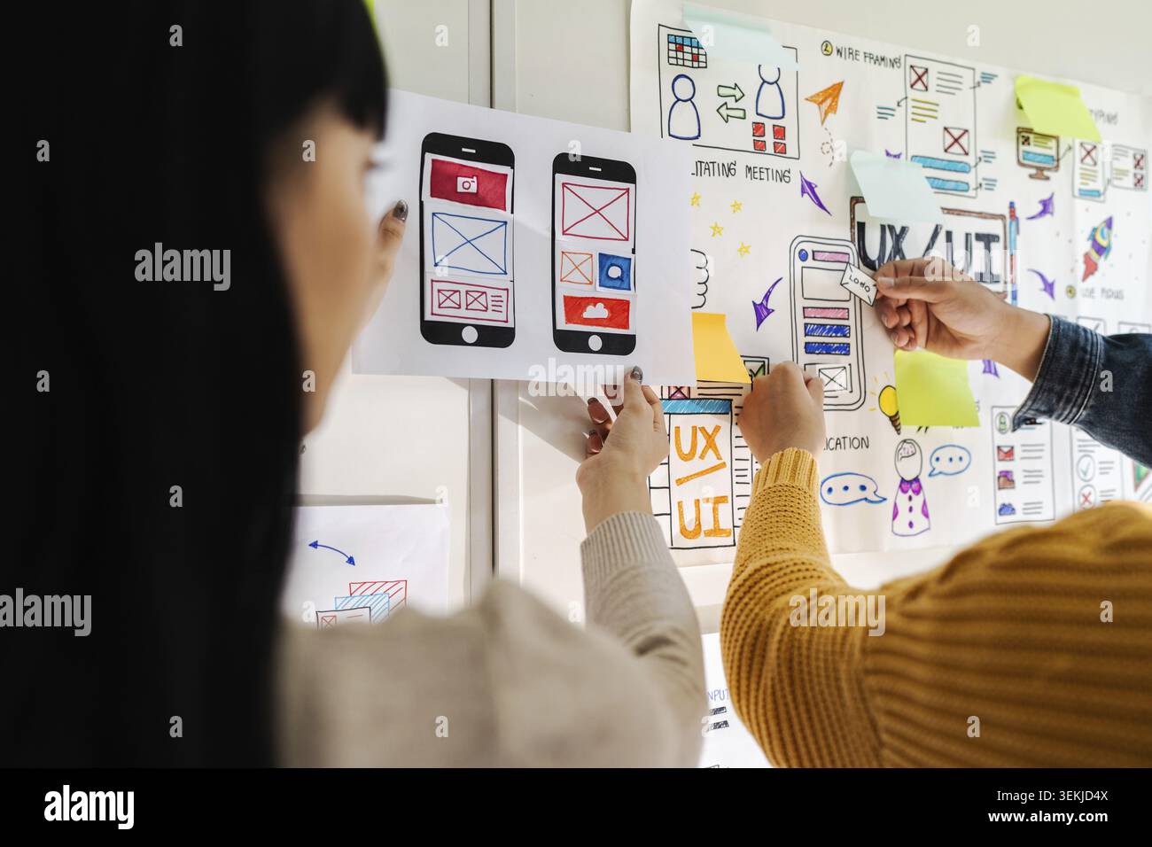 Close up ux developer and ui designer brainstorming interface wireframe design.Creative digital development agency Stock Photo