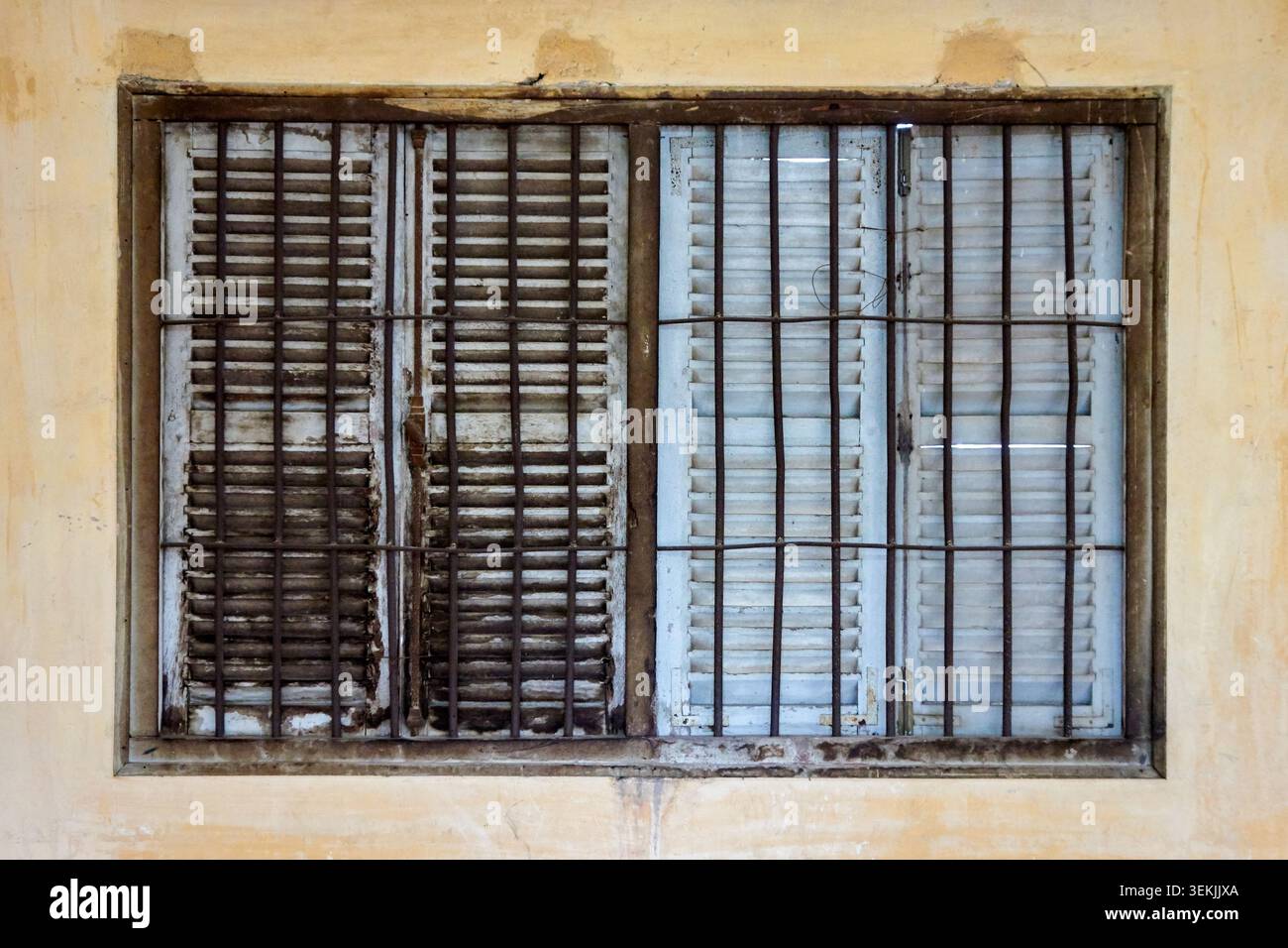 Weathered Shuttered Window with Security Bars in Cambodia Stock Photo