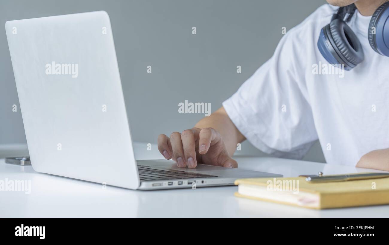 Closeup shot of hands using laptop and typing on keyboard, searching information Stock Photo