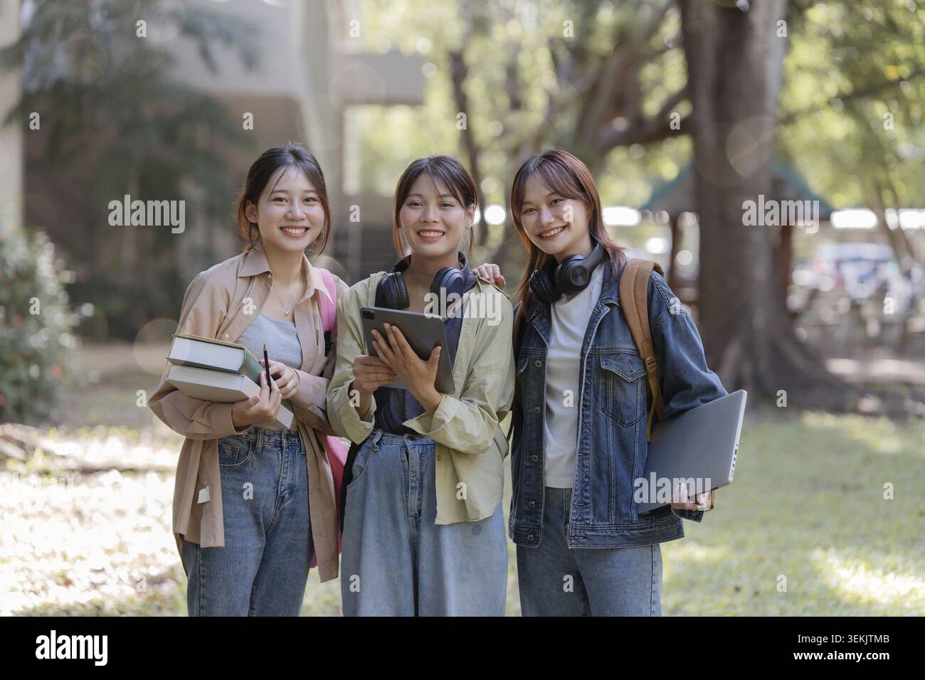 University students using a digital tablet while walking to next class Stock Photo
