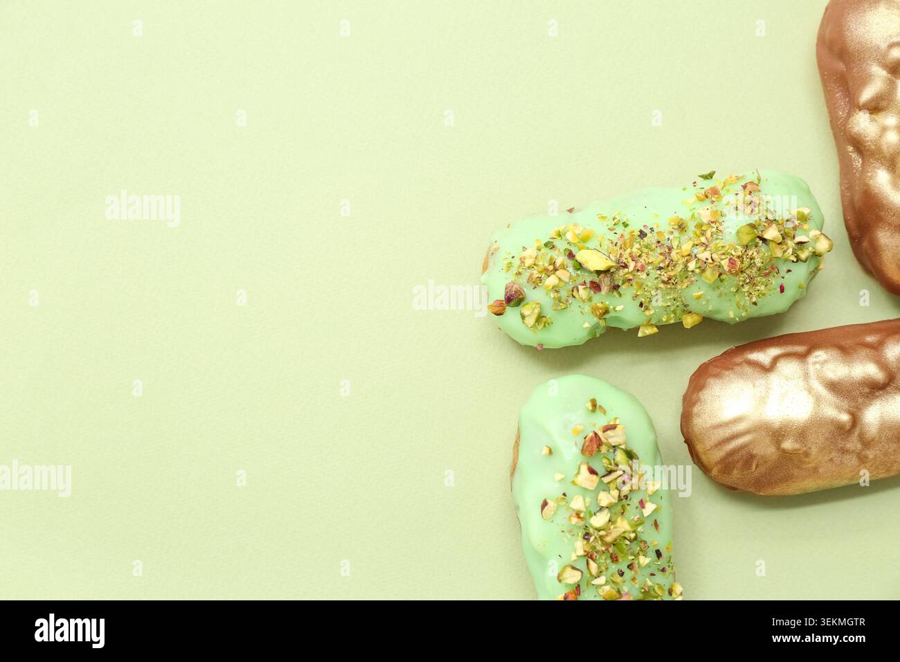 Composition with tasty glazed eclairs on color background Stock Photo