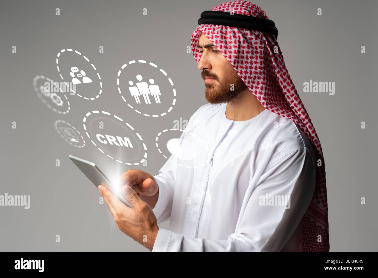 Middle Eastern man using tablet to manage customer relationship software features Stock Photo