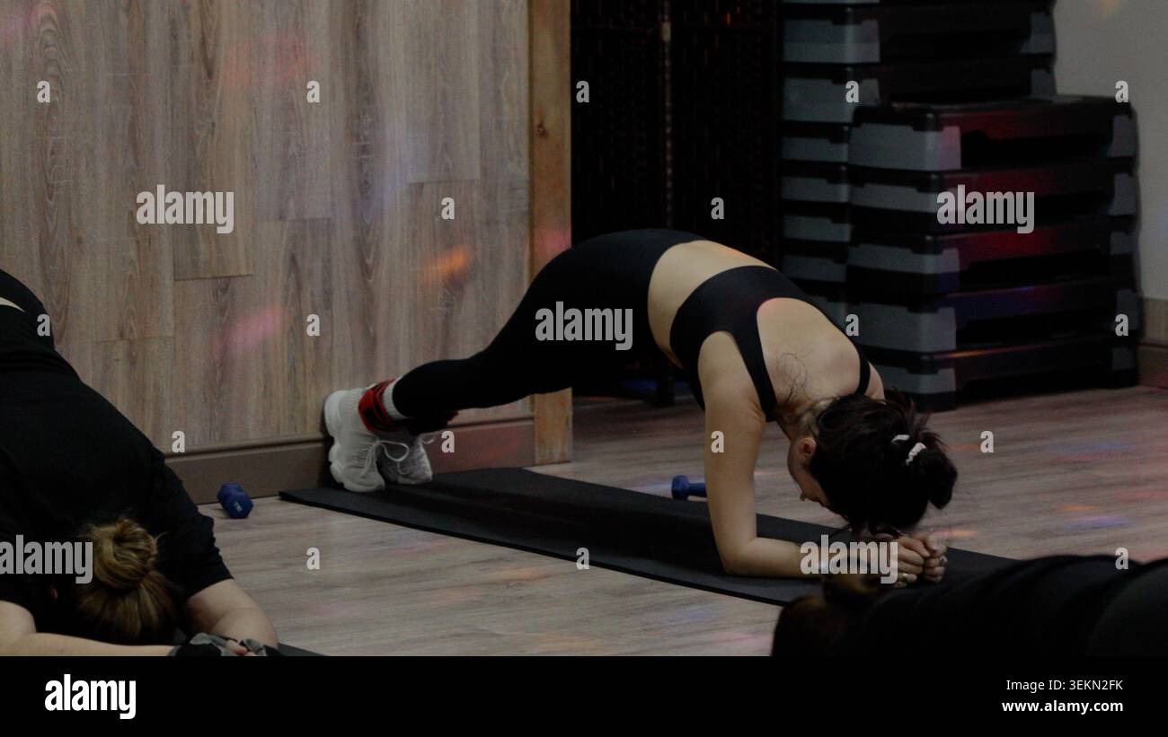 Fit athletic young woman doing core plank exercise on yoga mat Stock Photo