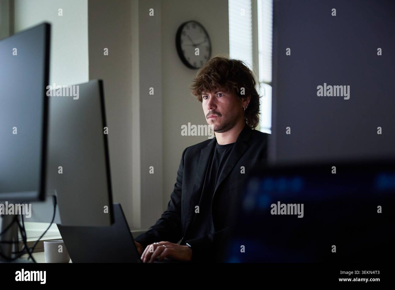 Focused male creative professional working on technologies in tech office Stock Photo