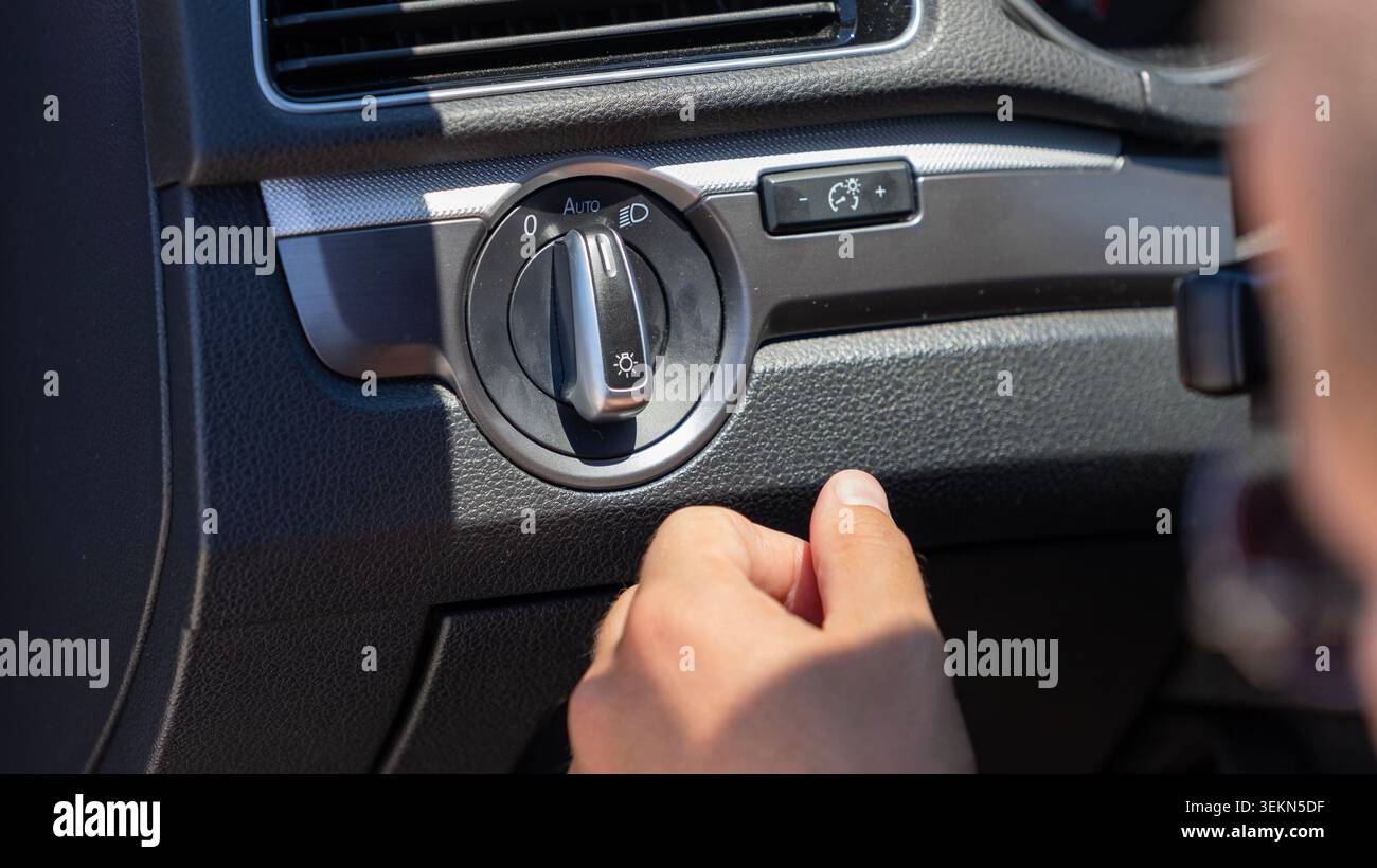 Driver Adjusting Car Headlight Control Switch Close Up Stock Photo