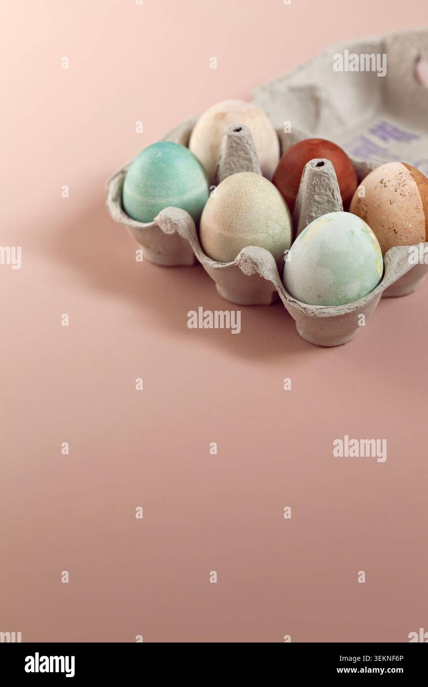 Colorful Easter Eggs arranged in tray over beige background Stock Photo