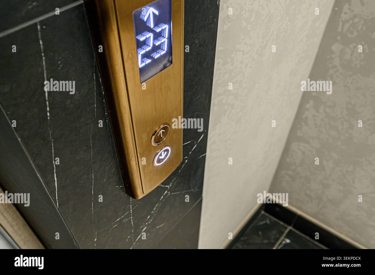 Elevator panel showing floor numbers on a marble wall. Stock Photo