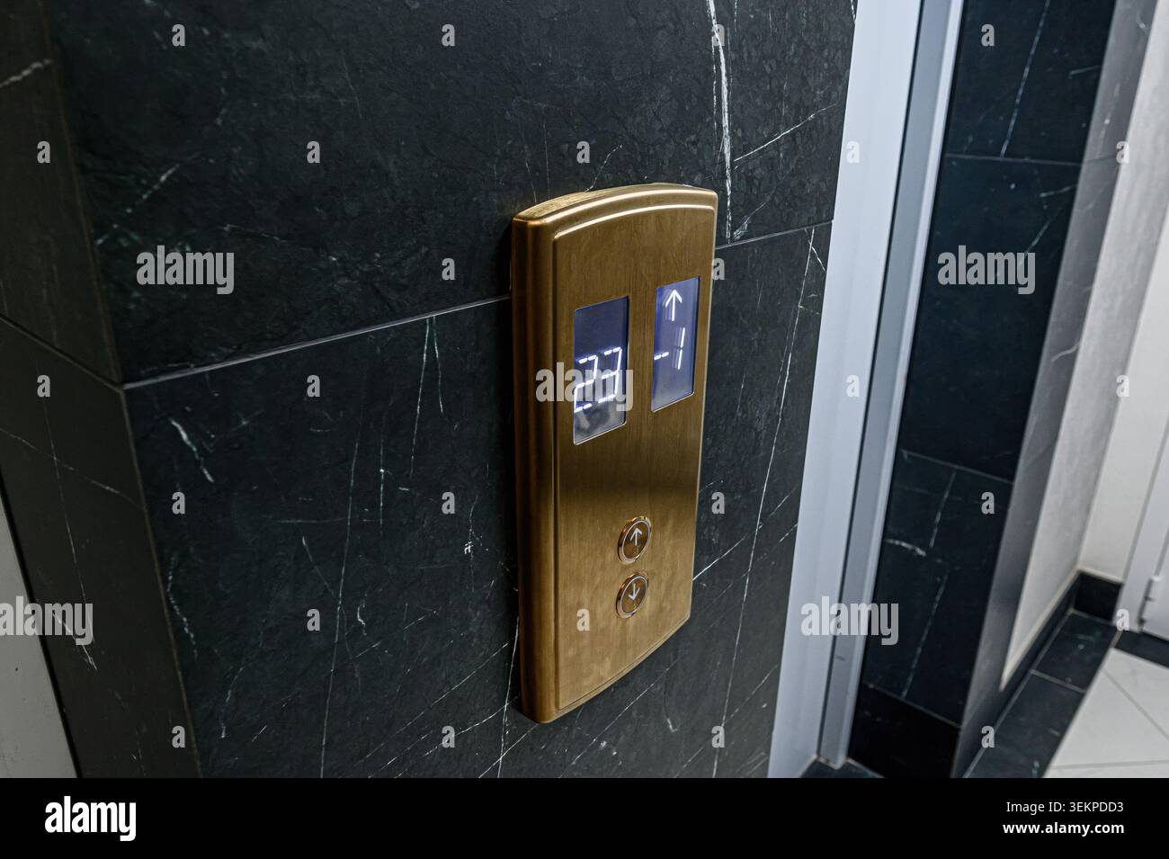 Elevator panel showing floor numbers on a marble wall. Stock Photo