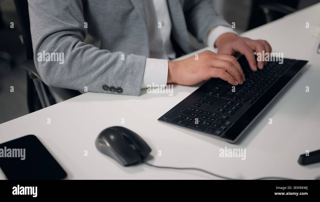 Cropped view male hands typing computer using mouse browsing internet chatting e-mail virtual chat unrecognizable business man working with pc device Stock Photo