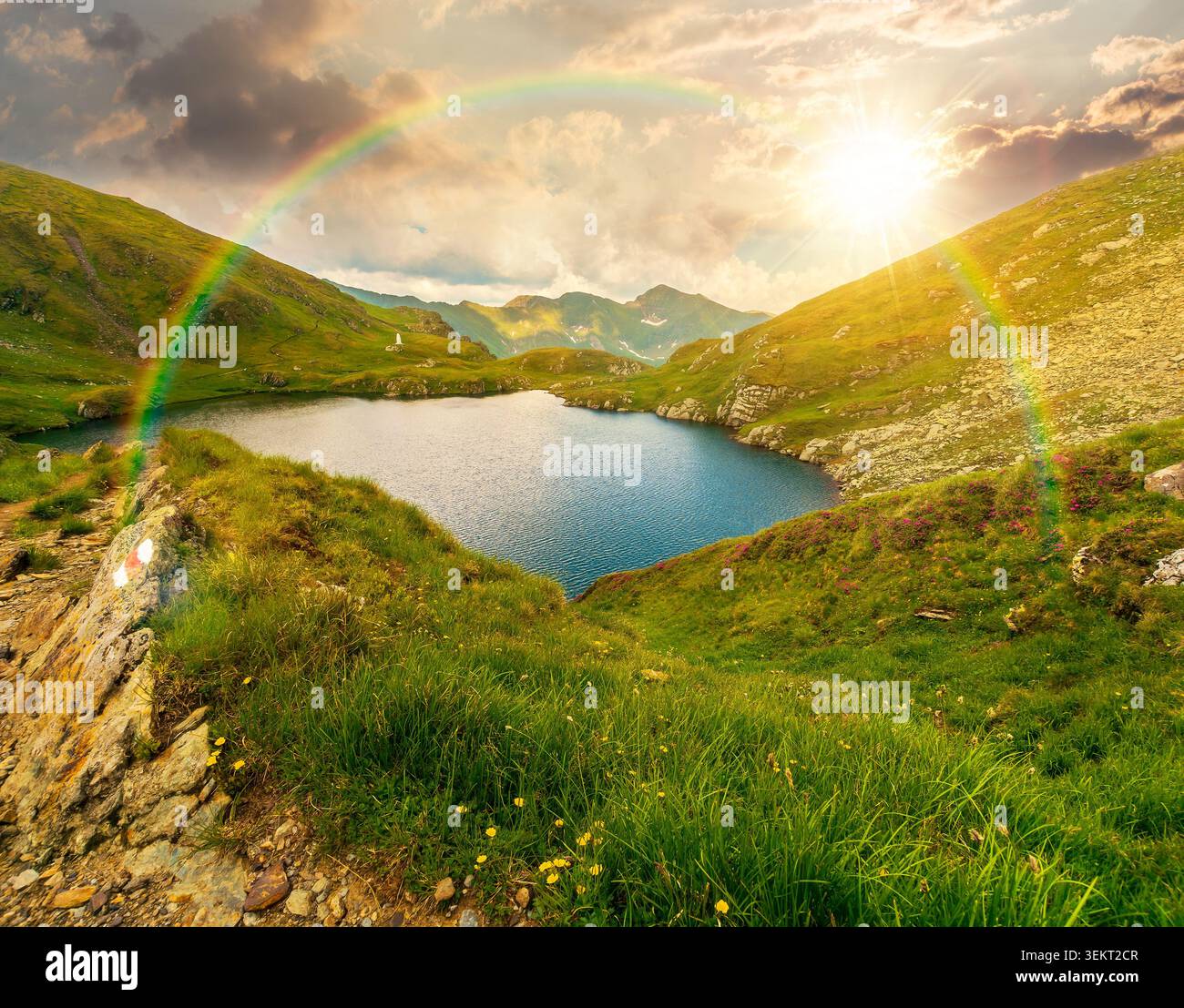 sunset over lovely summer scenery of alpine capra lake with steep slopes. nice view of transylvania alps, sibiu county. southern carpathian mountains Stock Photo