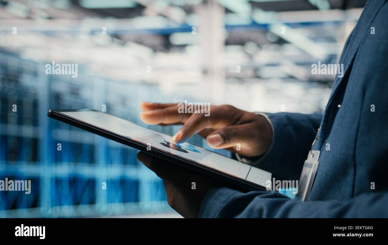 Using AI software, tablet close up and engineer in data center optimizing performance and forecasting issues. Automating operations, artificial intelligence and programmer in data center , camera A Stock Photo