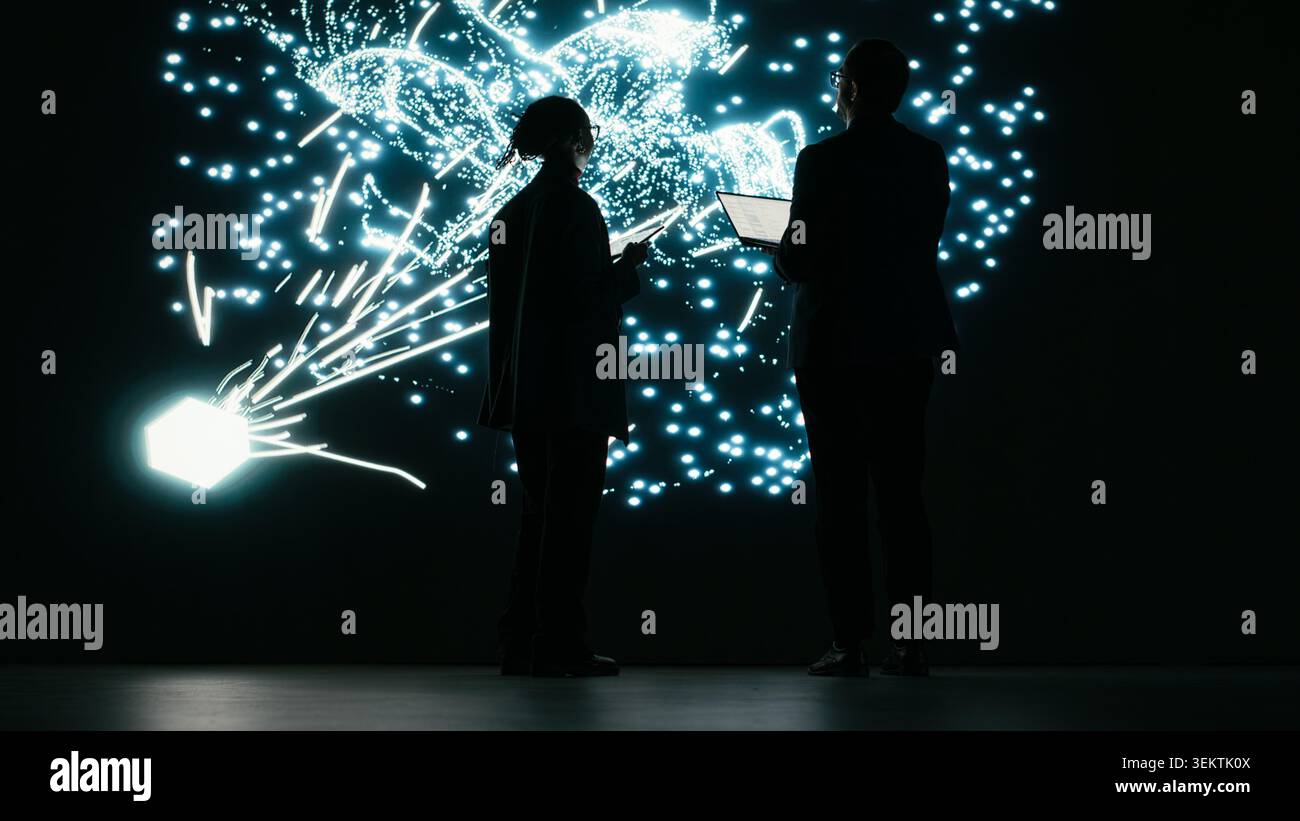Adjusting AI parameters, machine learning model and engineering team doing optimizations. Modifying datasets, neural network architecture projection and colleagues in tech startup brainstorm, camera B Stock Photo