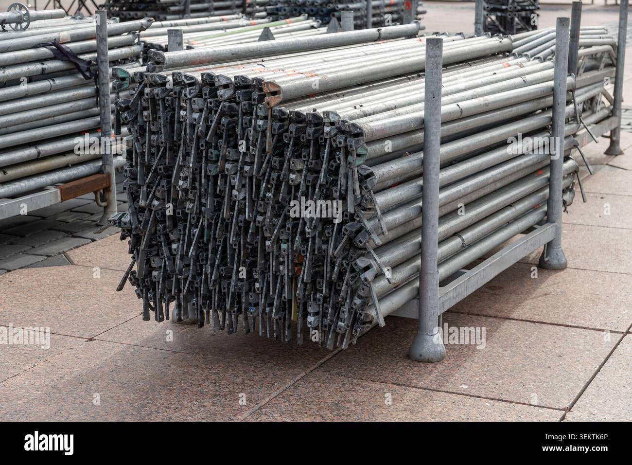 Large stack of metal scaffolding pipes and clamps on racks, prepared ...