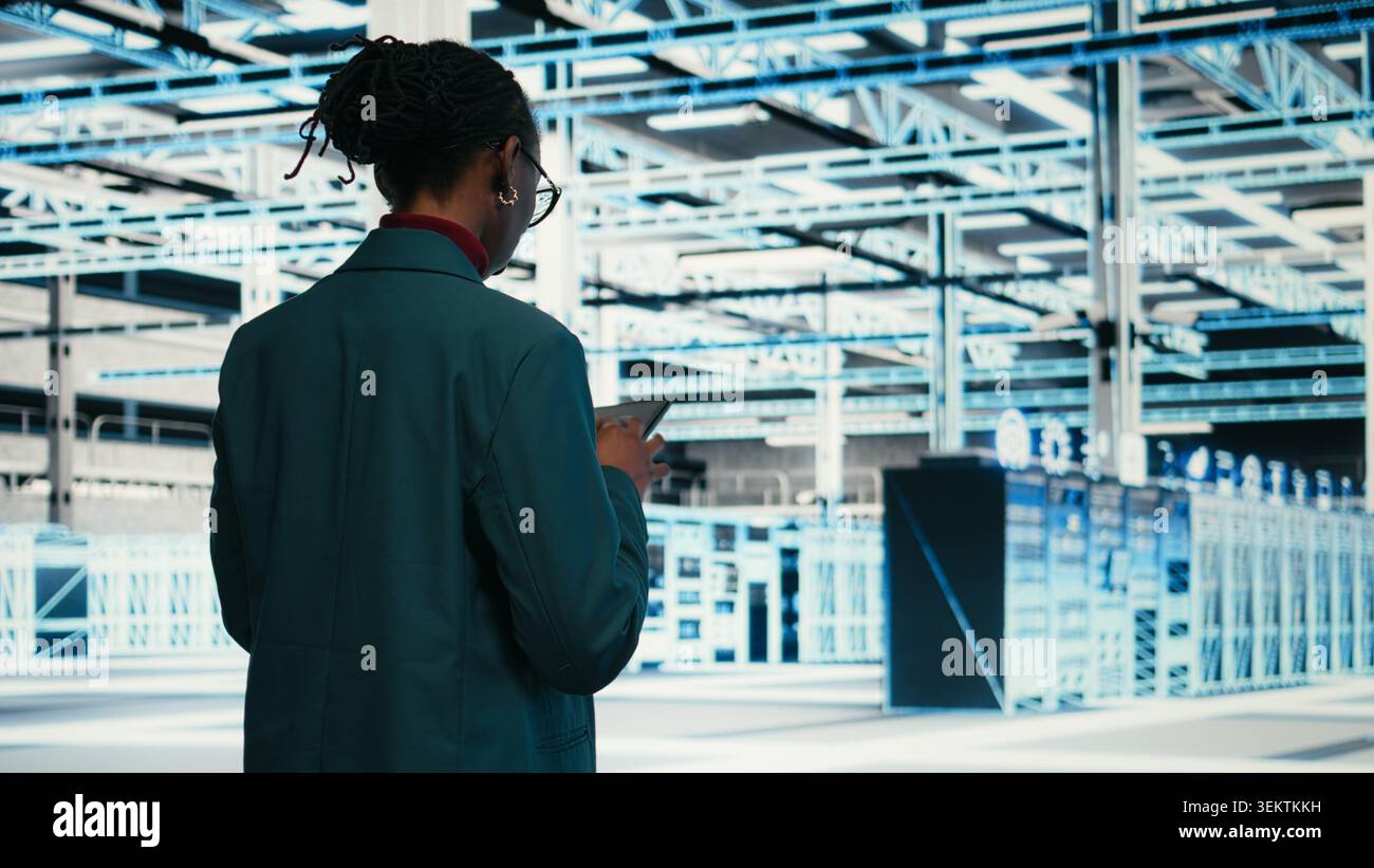 Writing code, tablet and female programmer walking in data center, compiling software patches. Running programming script, device application and African american woman in server hub, camera A Stock Photo