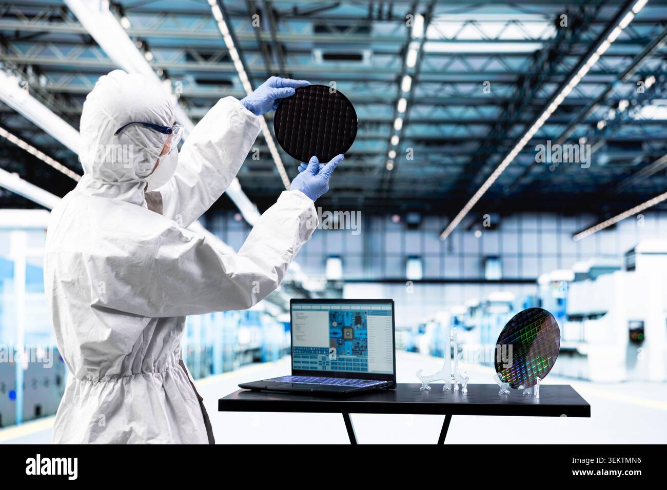Processing silicon wafer, EDA software and engineer man in automated manufacturing facility. Inspecting delicate microelectronic hardware, laptop program and technician doing quality control Stock Photo