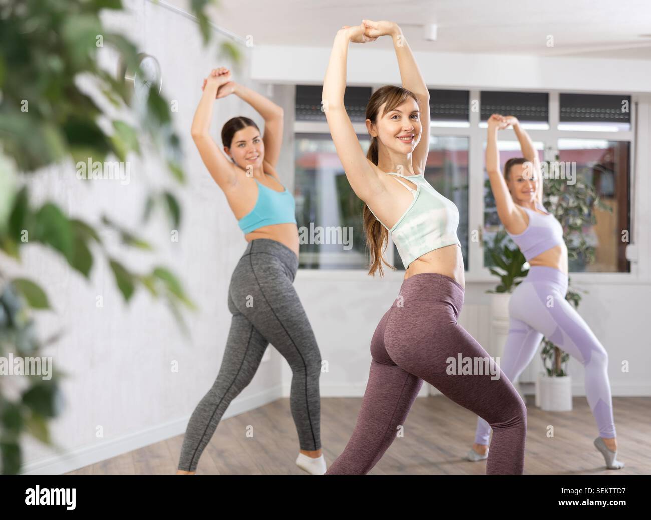 Happy women practicing aerobics in light fitness studio Stock Photo