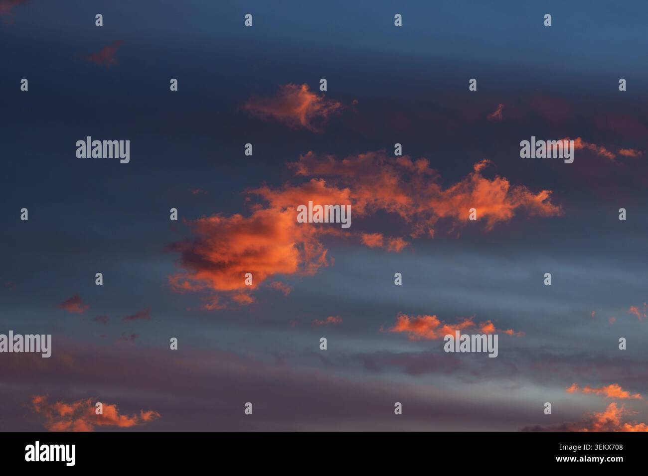 Vibrant fiery orange-red clouds at sunset. Stock Photo