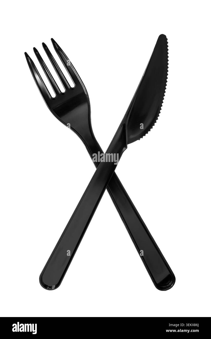 Crossed black plastic fork and table knife isolated on white background Stock Photo