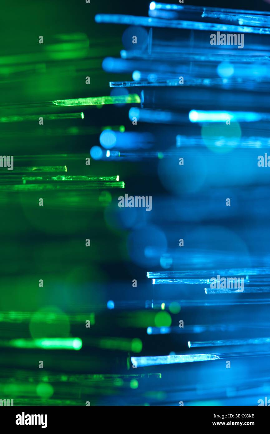 Glowing blue and green fiber optic cables texture background. Bright abstract digital technology Stock Photo