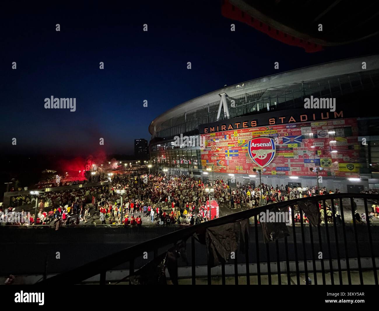 Arsenal supporters gather outside Emirates Stadium during celebrations in North London, England, following Arsenal's Premier League title success. - Smartphone Captured Stock Image
