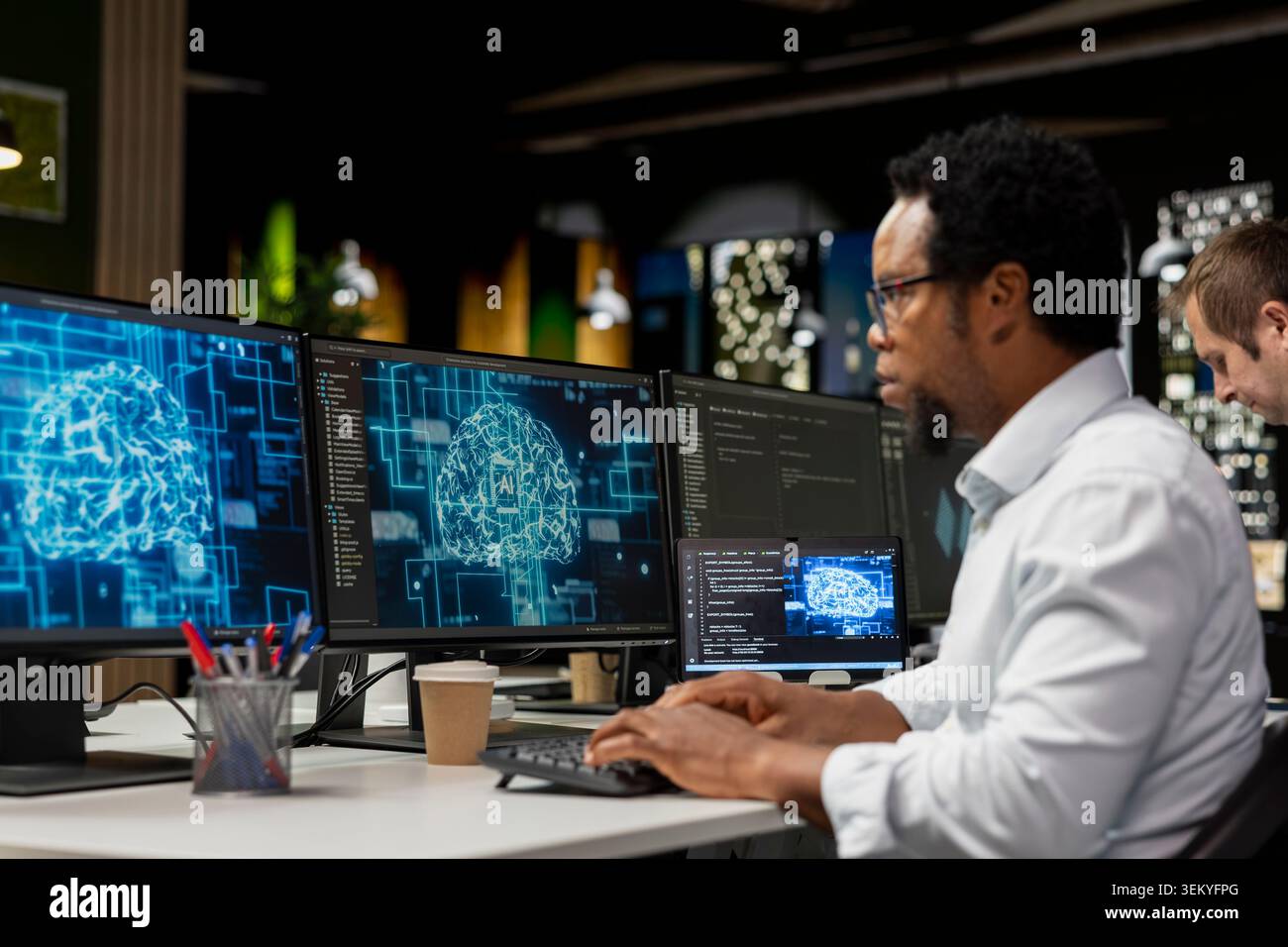 Admin using computer in tech startup office to develop programs using AI automation. African american IT professional working on PC, debugging applications with artificial intelligence Stock Photo