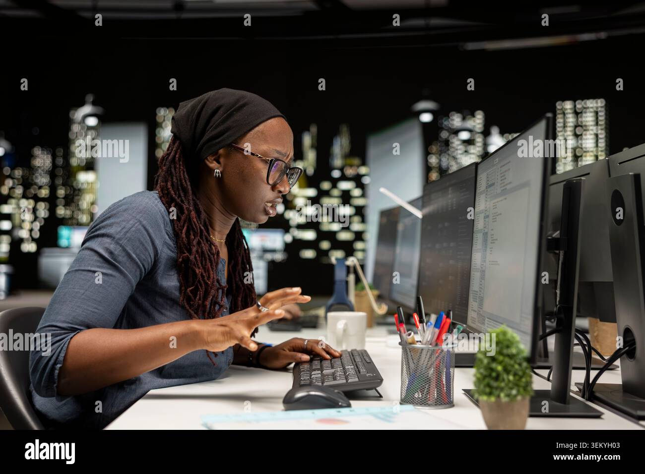 Technician typing on PC keyboard in startup office, optimizing code for performance and scalability, doing quality assurance. IT worker looking at programming language on computer Stock Photo