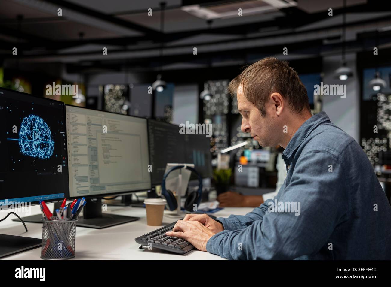 Computer scientist using machine learning in tech startup office to develop programs using AI automation. IT expert typing on PC keyboard, debugging applications with artificial intelligence Stock Photo