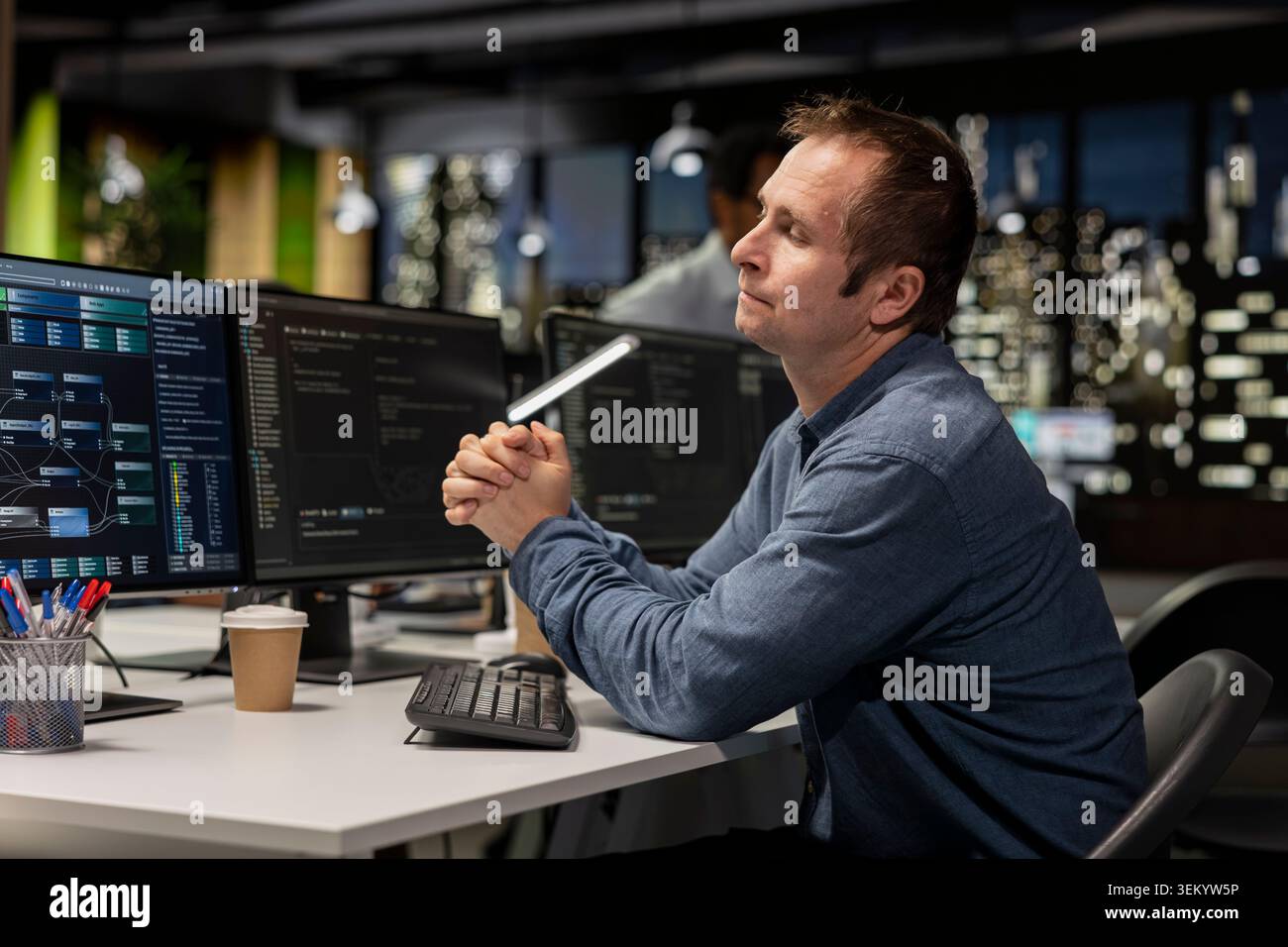 Startup software developer writing code on PC, leveraging AI tech to gain competitive edge. Worker using artificial intelligence coding script on computer, working on technological advancements Stock Photo