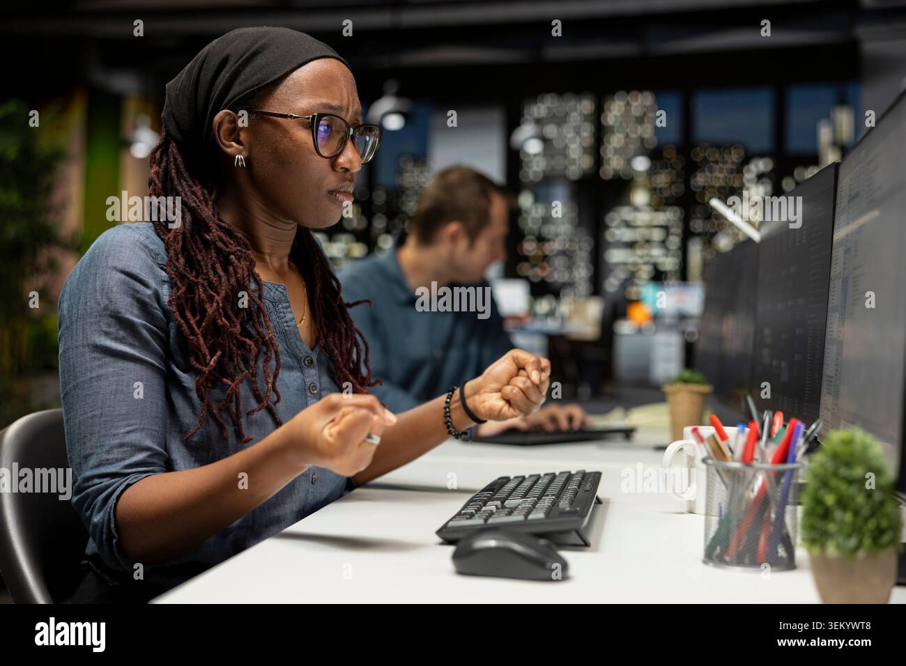 Programmer in tech startup office optimizing code for performance and scalability, doing quality assurance. IT professional at work looking at programming language on computer monitor Stock Photo