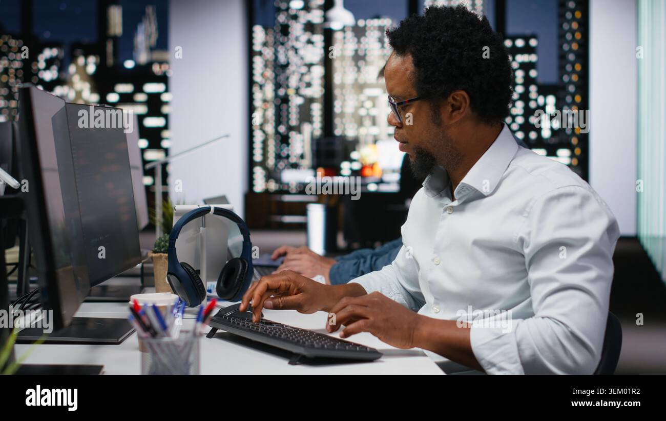 Software developer in company workplace doing artificial intelligence tech quality assurance. IT startup employee in office typing on keyboard, writing AI script with programming languages Stock Photo