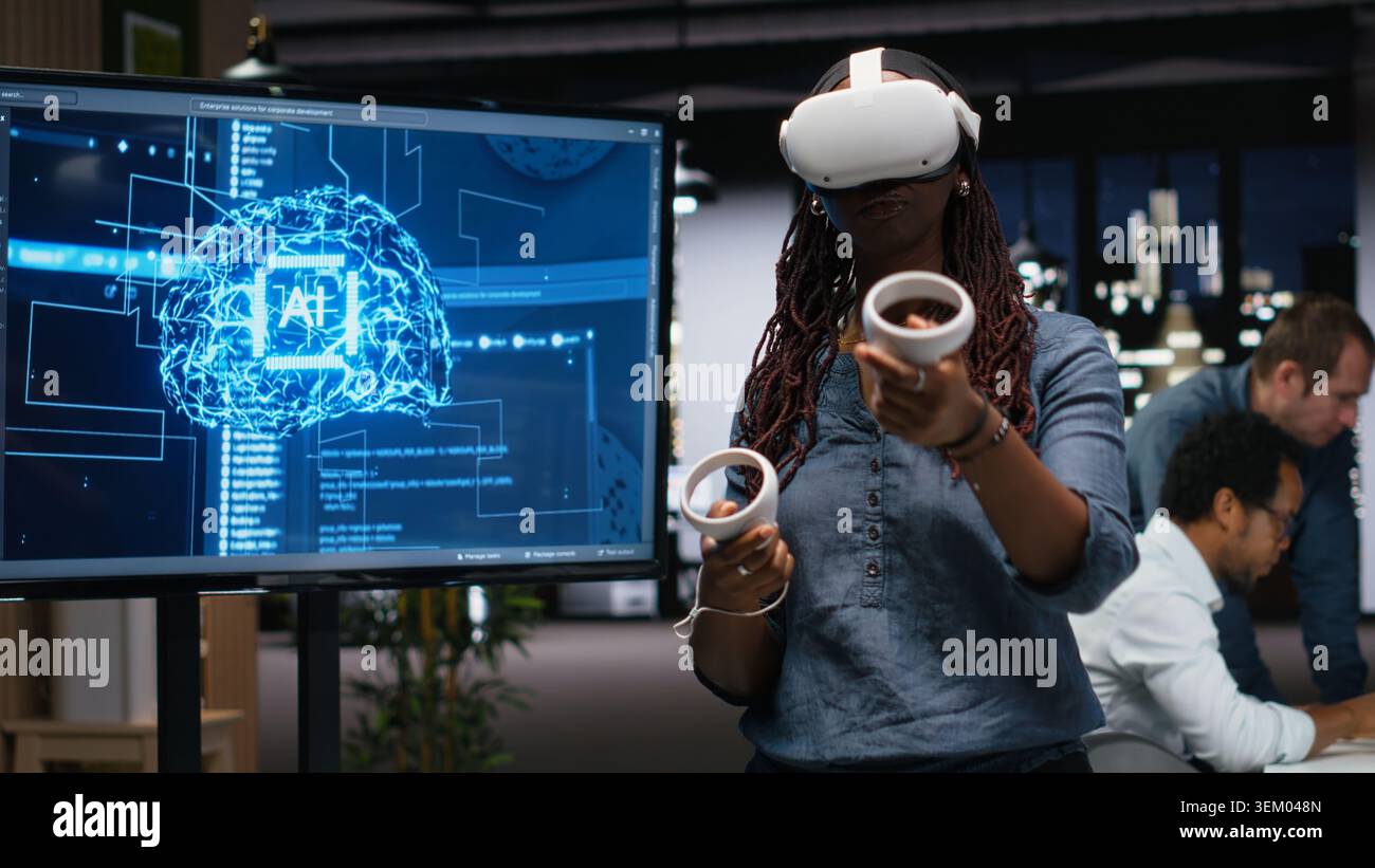 Developer in office using VR headset gear to analyze machine learning algorithms. IT expert uses virtual reality equipment to improve artificial intelligence prediction accuracy Stock Photo