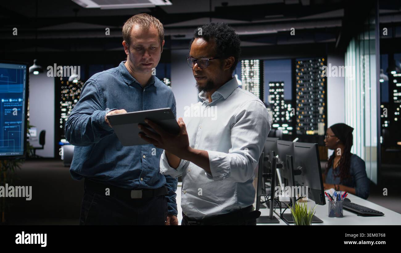 Engineers developing artificial intelligence algorithms in modern high rise office. IT experts debug applications while visualizing 3D neural network brain models on glowing screens Stock Photo