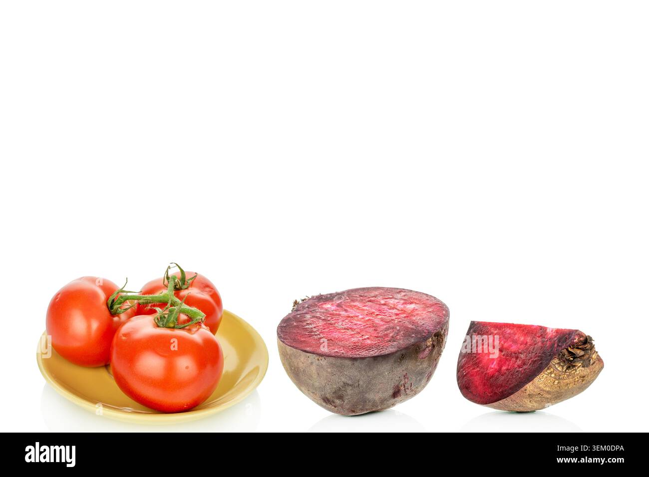 Red tomatoes with red beets, on a white background, close-up. Stock Photo