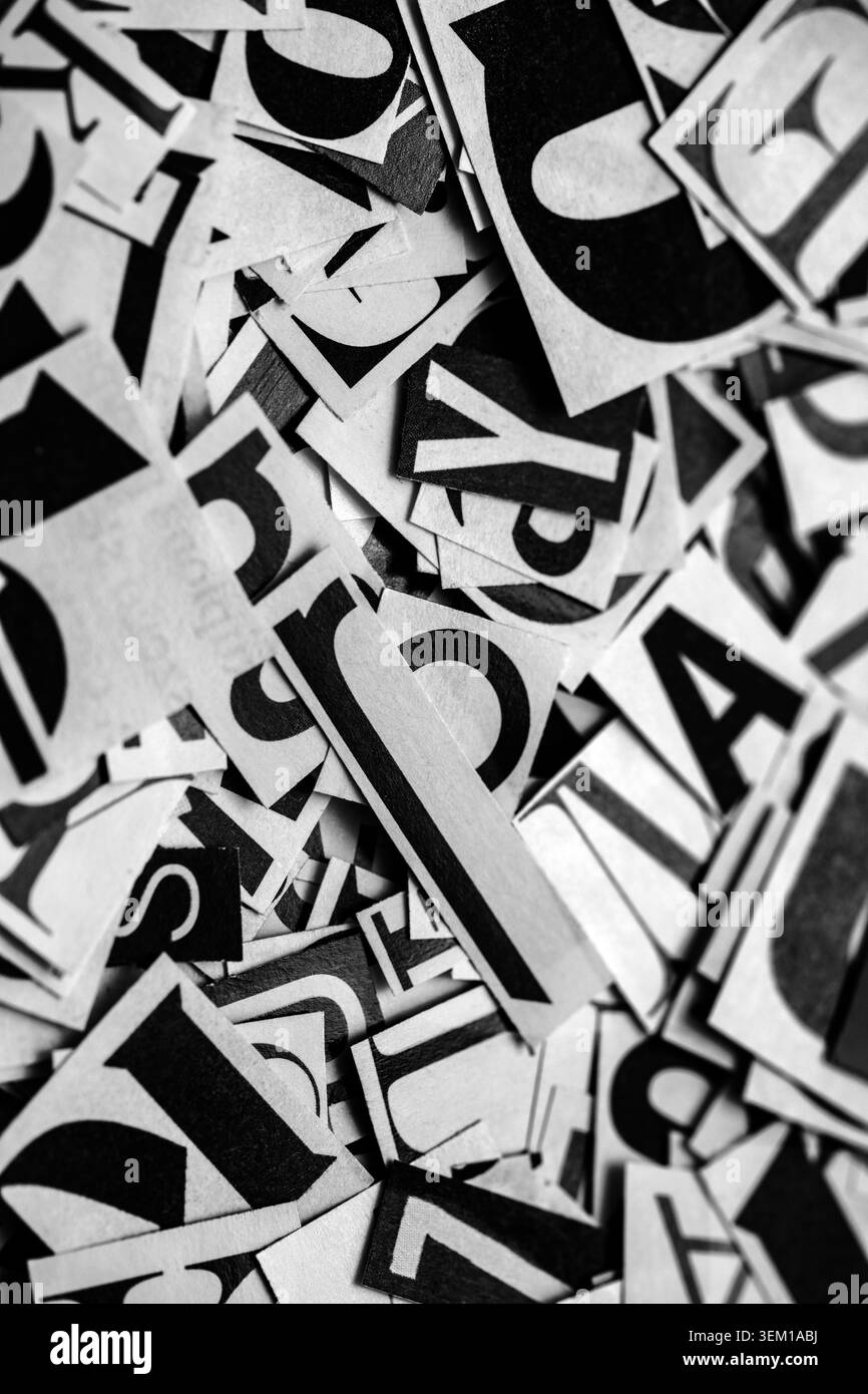 Pile of many black and white letters from newspapers and magazines. Typography background composition. Stock Photo