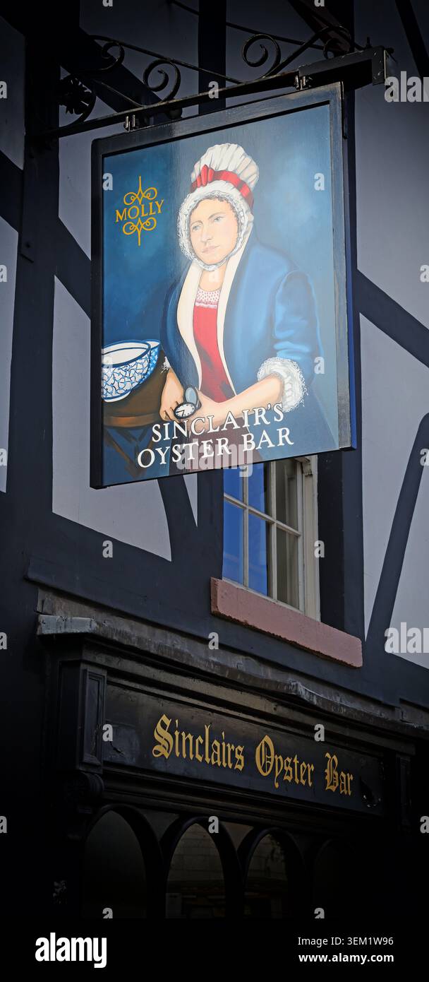 Sinclair's Oyster Bar hanging sign in Shambles Square, Manchester, England, UK, showing Queen Elizabeth II. Stock Photo