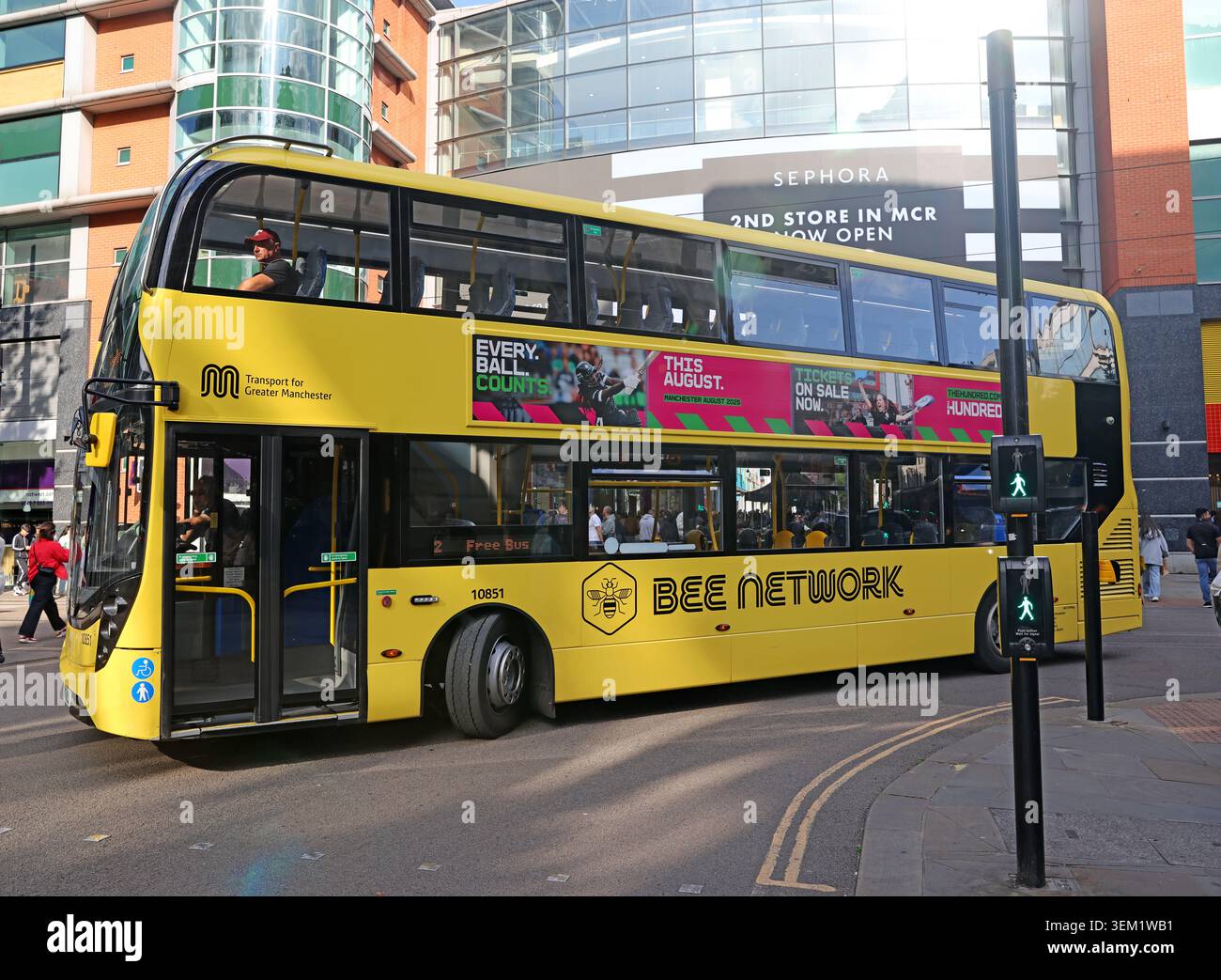 Manchester Bee Network free city bus in Manchester city centre, England, UK, carrying bright Bee Network branding. Stock Photo