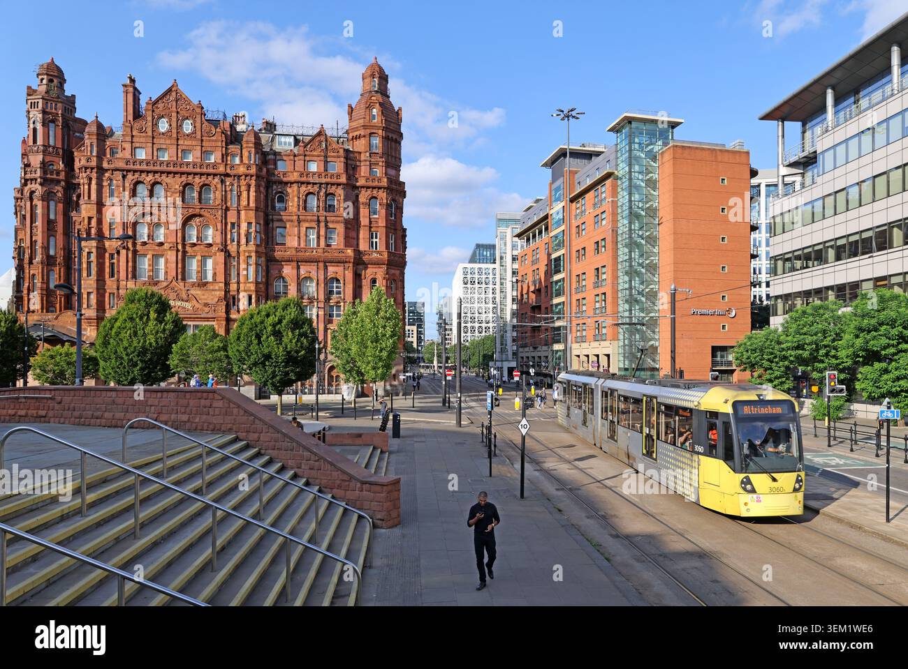 Midland Hotel and an Altrincham-bound Metrolink tram beside Manchester Central in Manchester city centre Stock Photo
