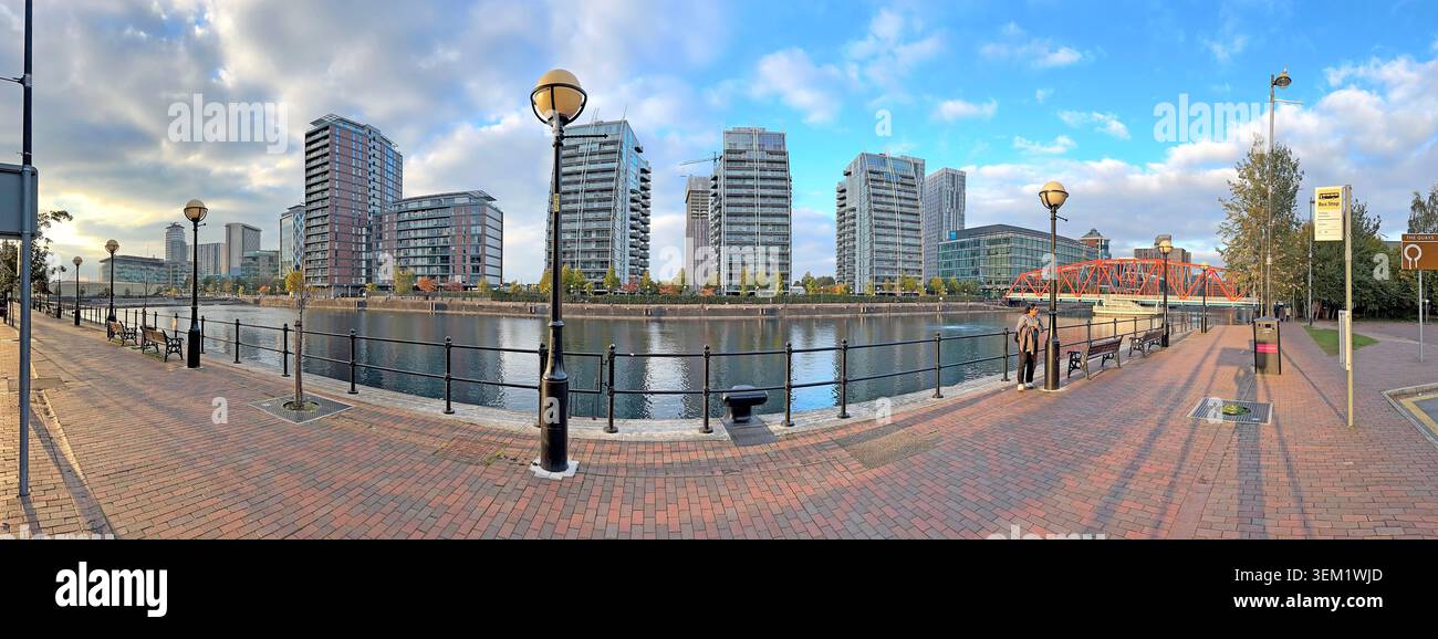 Sunset panorama across Salford Quays, showing waterfront apartments, modern towers and regenerated former dockland in Greater Manchester Stock Photo