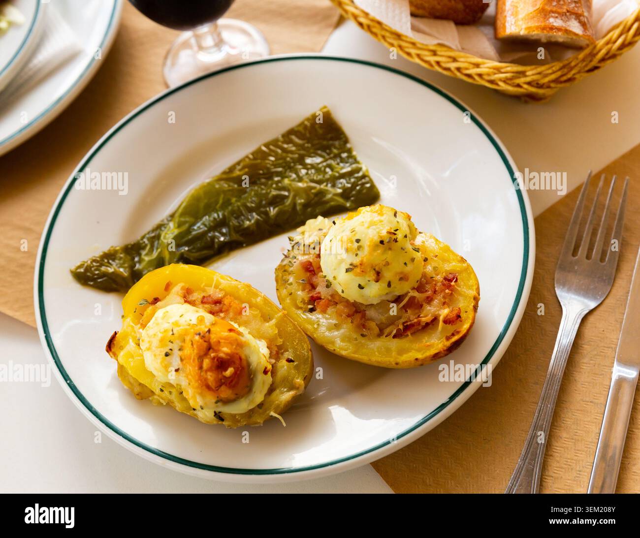 Potatoes stuffed with bacon, greens and eggs Stock Photo