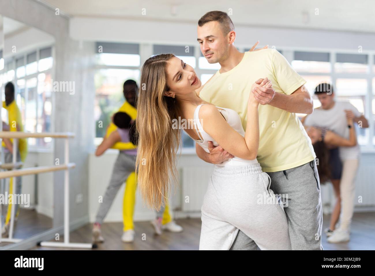Woman practicing passionate samba with man in dance class Stock Photo