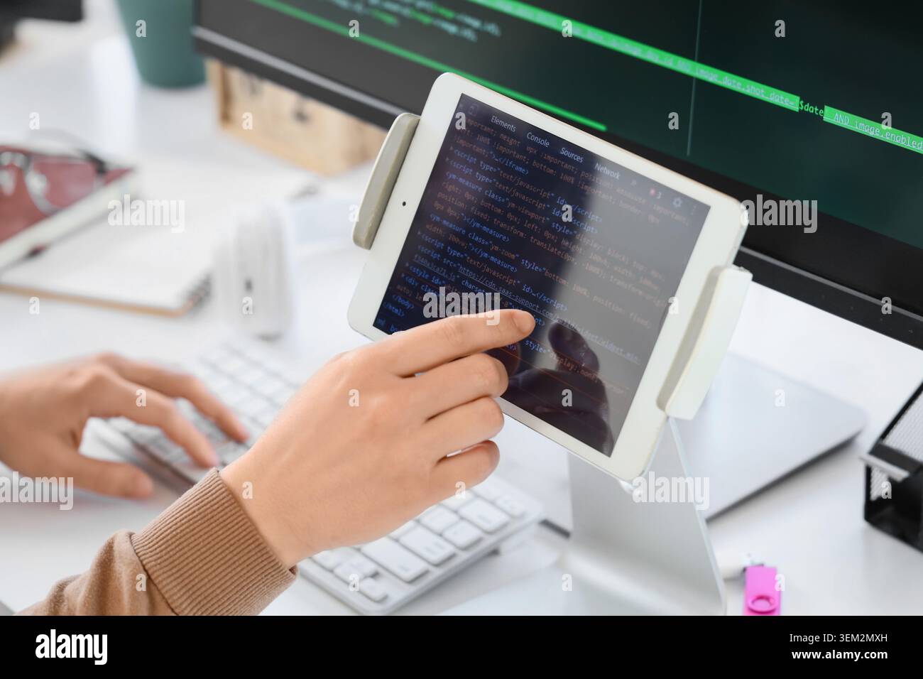 Female programmer's hands testing code on tablet computer in office, closeup Stock Photo