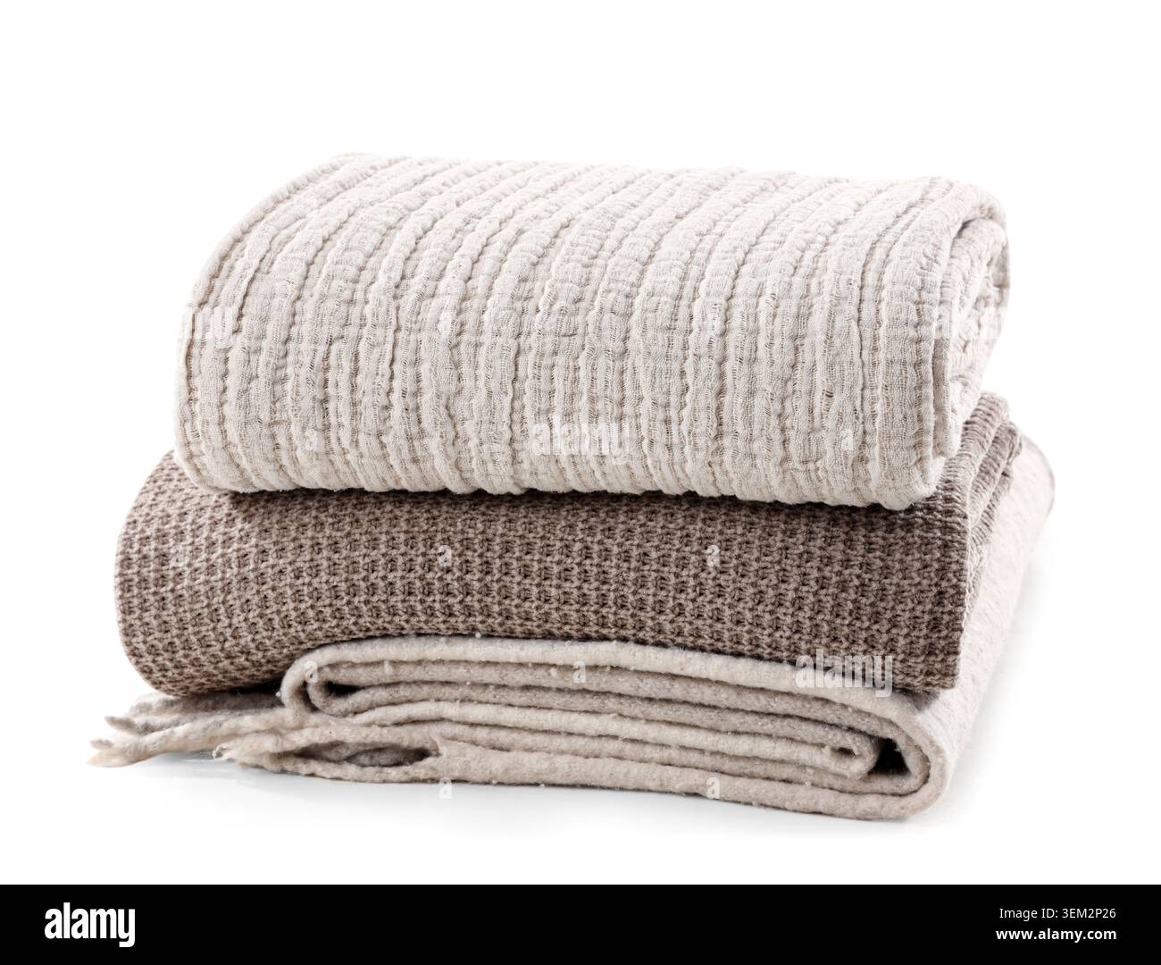 Stack of different cozy blankets isolated on white background Stock Photo
