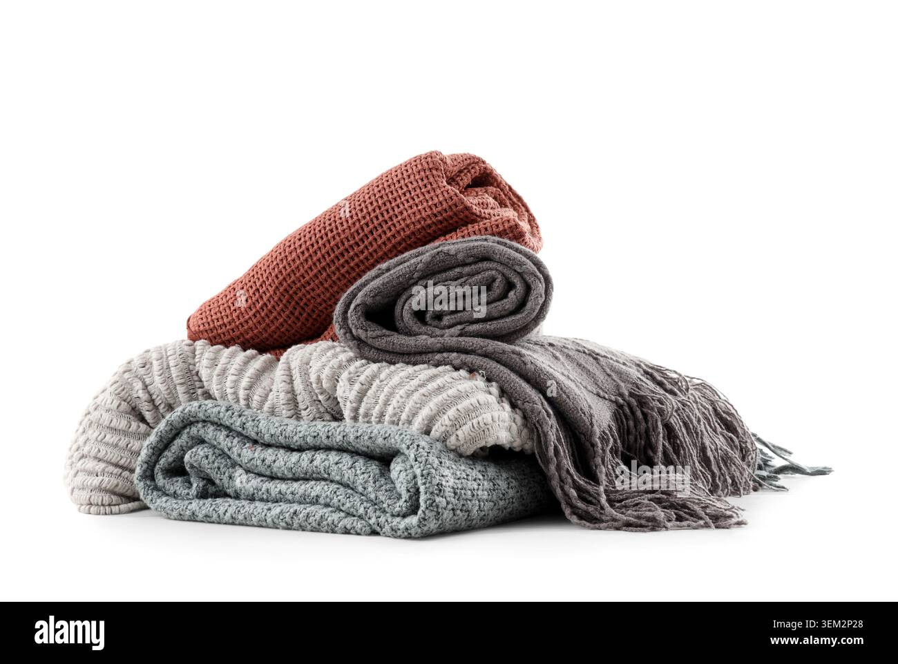 Stack of different knitted blankets isolated on white background Stock Photo